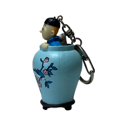 Porte-clés Tintin et Milou dans une potiche, illustration de Hergé, miniature détachable, accessoire de collection.