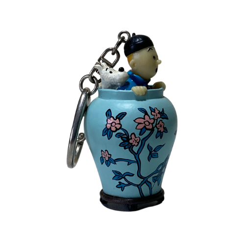 Porte-clé Tintin et Milou dans une potiche, illustration d'Hergé représentant le personnage de Tintin, accessoire de collection.