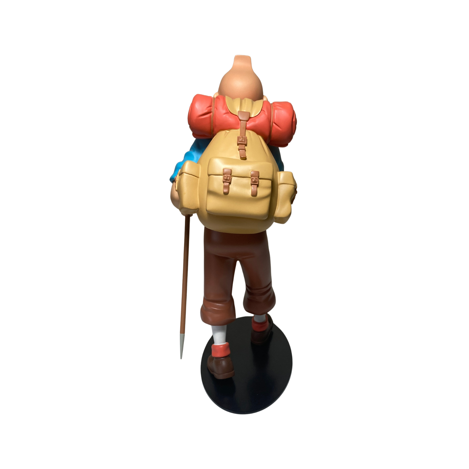 Figure de Tintin alpiniste en figurine détaillée, représentant l'aventurier dans une pose d'escalade.