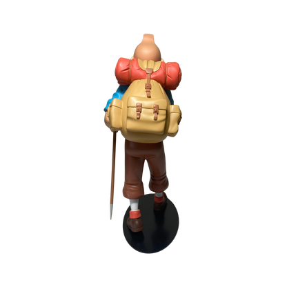 Figure de Tintin alpiniste en figurine détaillée, représentant l'aventurier dans une pose d'escalade.