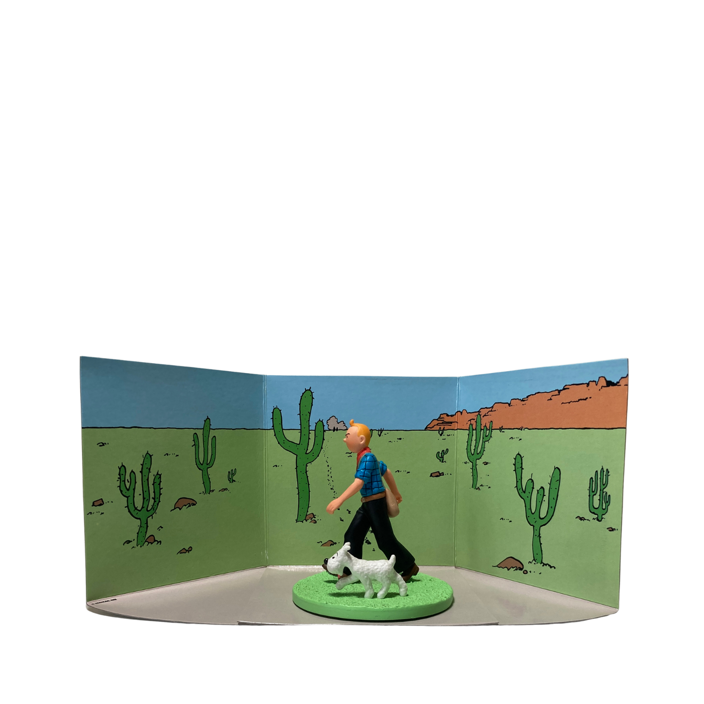 Figurine Tintin cowboy avec Milou, personnage de la bande dessinée, en détail, illustrant la scène avec précision.